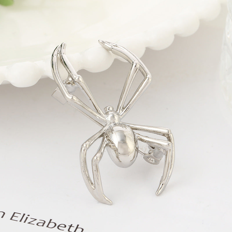 Silver spider brooches